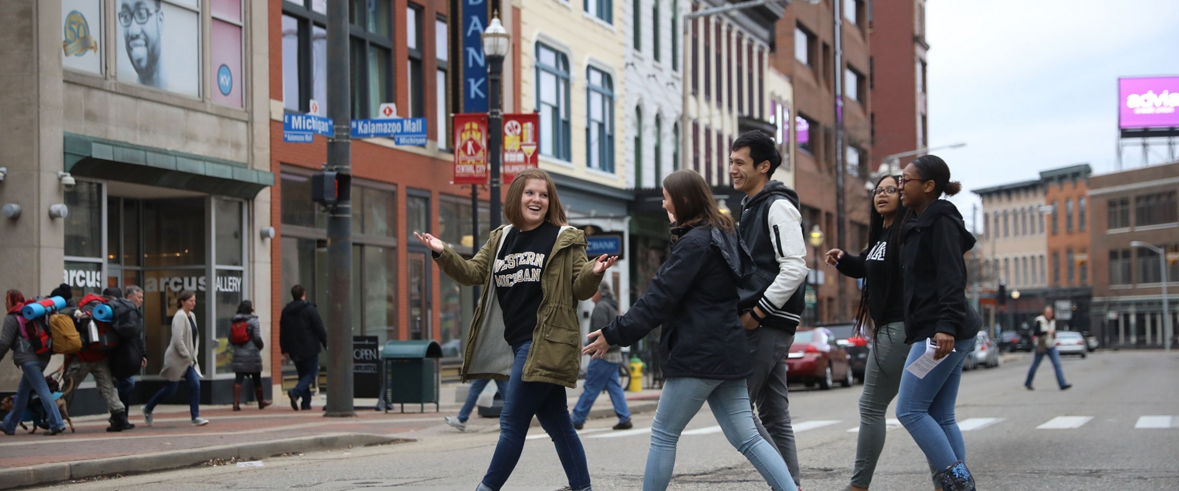 A group of WMU students cross West Michigan Avenue in downtown Kalamazoo